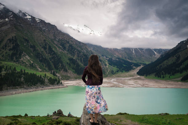 istock Handsome young woman is standing on the hill 954296264