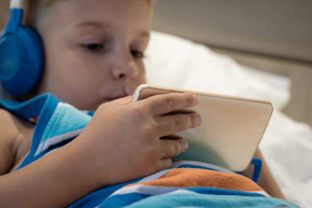 istock Close up of kid using smart phone and watching cartoon online. 954299746