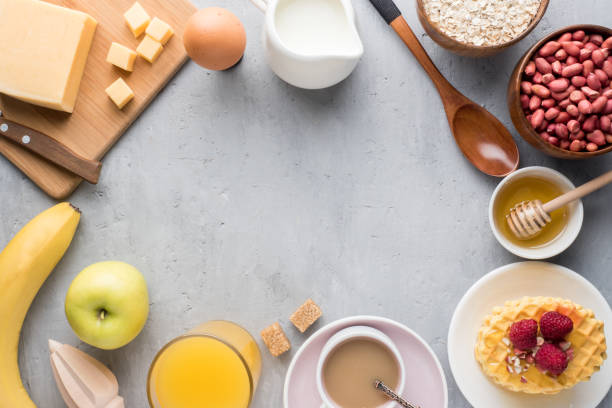 istock Healthy Breakfast Cheese Juice coffee Honey Peanuts Egg Biscuits Waffles Cereal Oatmeal Apple Banana. Selective focus. The view from the top. Flat position 954305238