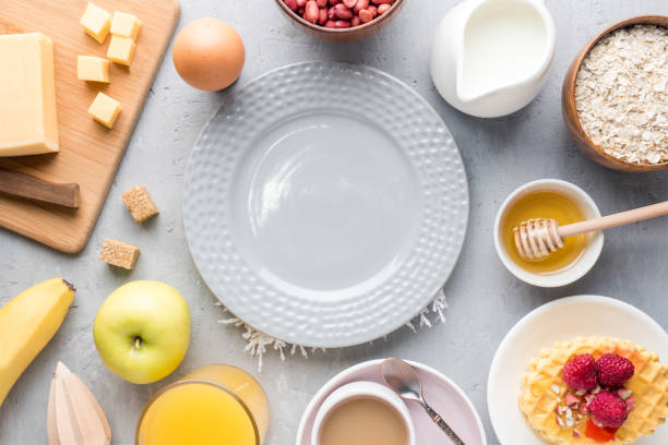 istock Healthy Breakfast Cheese Juice coffee Honey Peanuts Egg Biscuits Waffles Cereal Oatmeal Apple Banana. Selective focus. The view from the top. Flat position 954305532