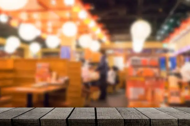 Empty wooden shelf display with Izakaya japanese restaurant background