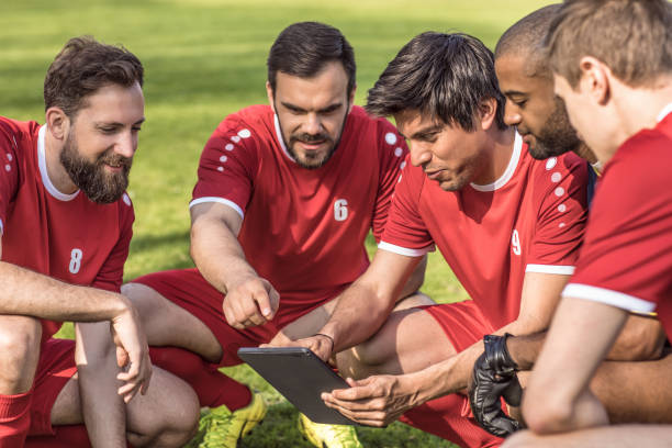 istock A soccer team looking at tactics on a tablet during a football training session 954314894
