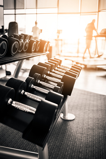 Rows of dumbbells in the gym with hign contrast and  color tone sport and health concept