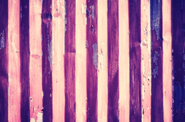 istock Weathered corrugated metal wall with peeling paint. 954317084