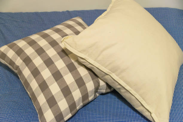 istock White and gray cushion on blue blanket with white stripes 954324940