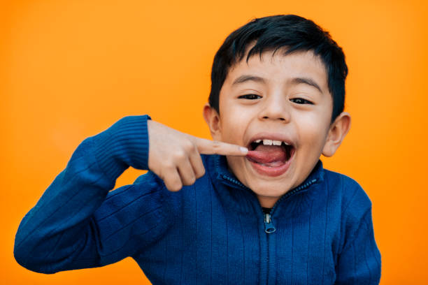 istock Little boy sticking out tongue 954325618
