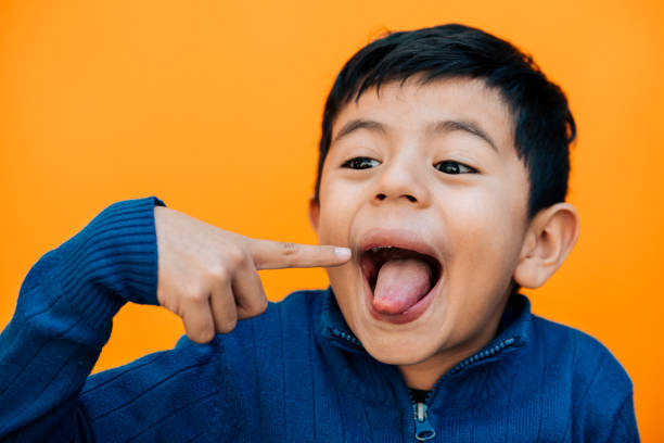 istock Little boy sticking out tongue 954325920