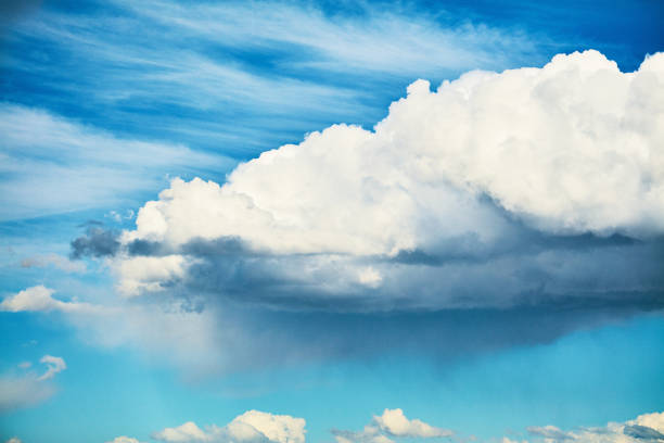 Big fluffy clouds in vibrant blue sky