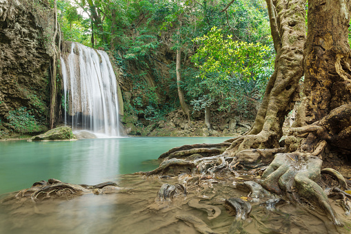 This is a horizontal color photograph of the lush landscape of Southeast Asia travel destination, Erawan Falls National Park in the Kanchanaburi province of Thailand. There are no people.