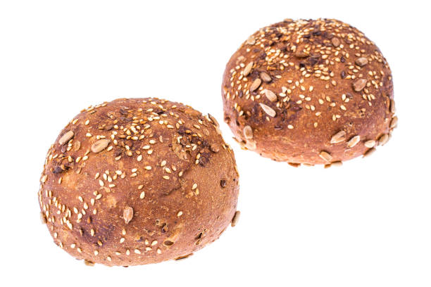 Round whole-wheat rye rolls with flax and sunflower seeds. Studio Photo