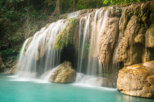 This is a horizontal color photograph of the lush landscape of Southeast Asia travel destination, Erawan Falls National Park in the Kanchanaburi province of Thailand. There are no people.