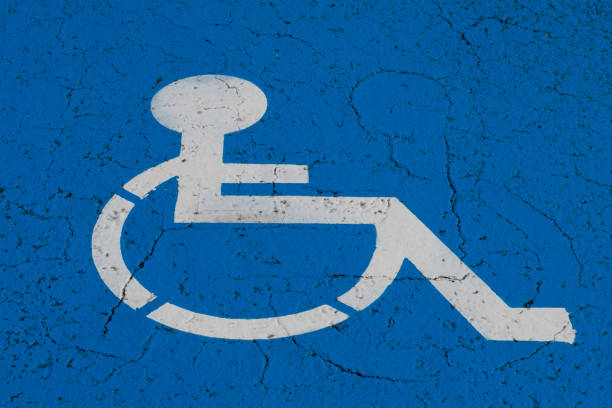 istock wheelchair symbol on handicap parking spot 954338606