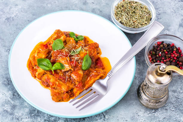 istock Fillet meat chicken, turkey with paprika and tomatoes 954338626