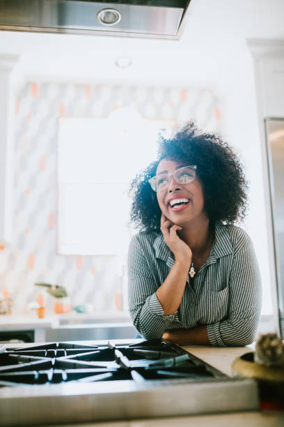 istock A Young Woman Relaxes in Her Modern Home Kitchen 954339688