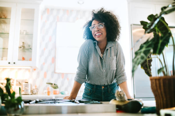 A Young Woman Relaxes in Her Modern Home Kitchen