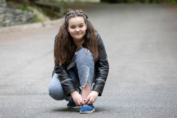 istock girl s tying up sneakers 954343122