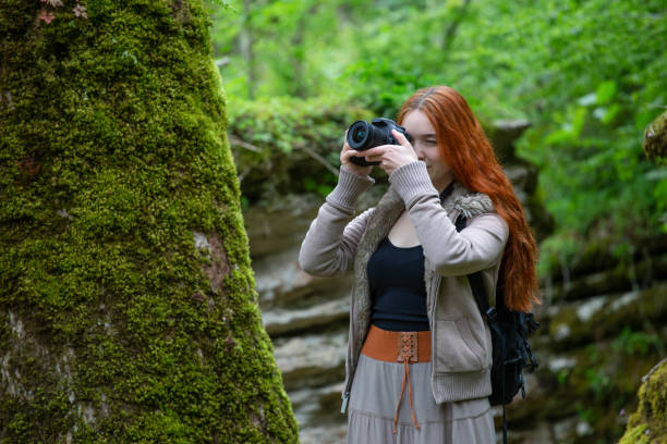 istock girl-photographer in the forest 954343228