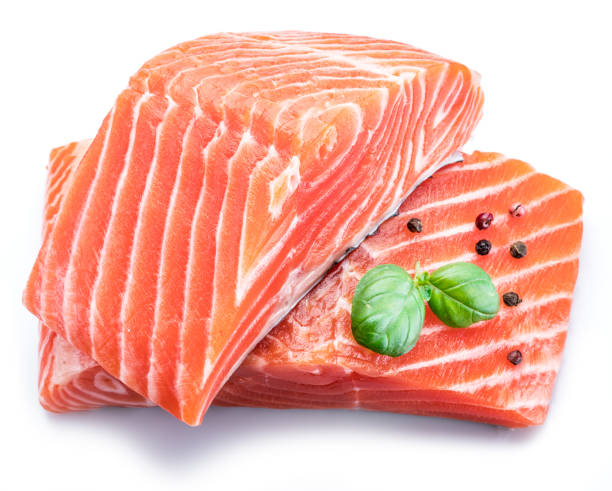 istock Fresh raw salmon fillets  decorated with green basil. 954344288