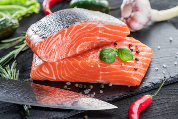 istock Fresh salmon fillets on black cutting board. 954344428