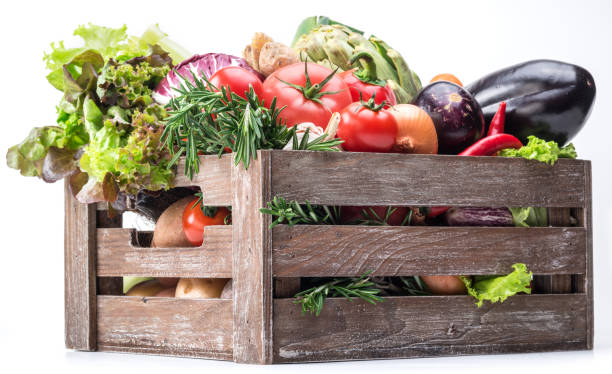 Fresh multi-colored vegetables in wooden crate. Fresh multi-colored vegetables in wooden crate. White background. Artichoke stock pictures, royalty-free photos & images