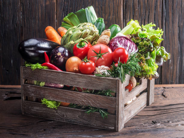 istock Fresh multi-colored vegetables in wooden crate. 954348022