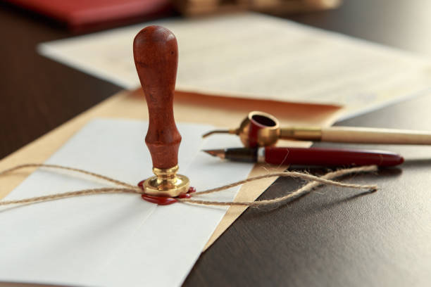 istock Notary pen lying on testament. Notary public working accesories 954348460