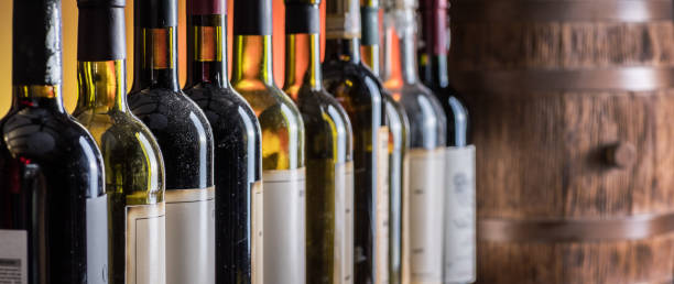 Wine bottles in row. Wine bottles in row and oak wine keg. barrel photos stock pictures, royalty-free photos & images