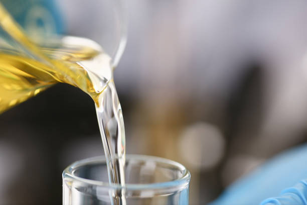 istock Male hands in protective gloves hold test tube 954353746