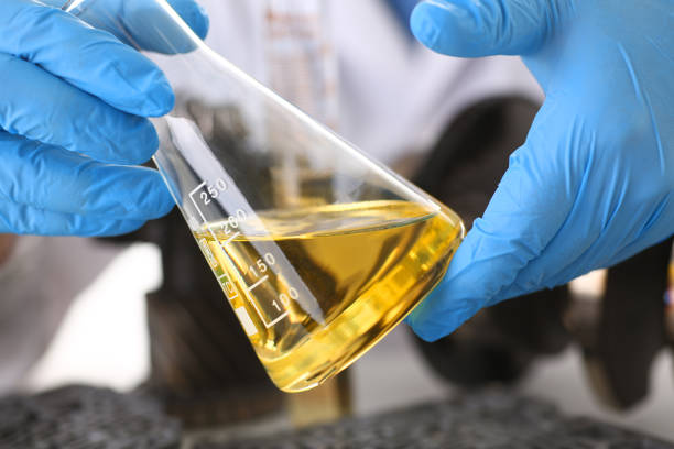 Male hands in protective gloves hold test tube