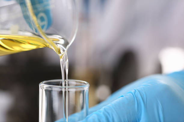 istock Male hands in protective gloves hold test tube 954353754