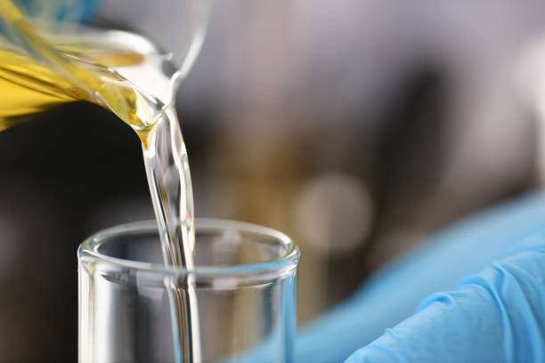istock Male hands in protective gloves hold test tube 954353760