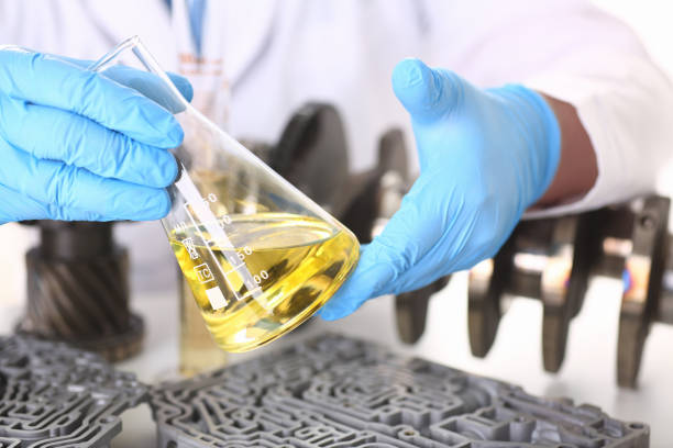 istock Male hands in protective gloves hold test tube 954353776