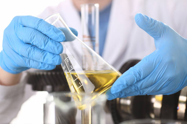istock Male hands in protective gloves hold test tube 954353786