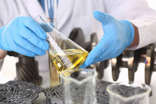istock Male hands in protective gloves hold test tube 954353796