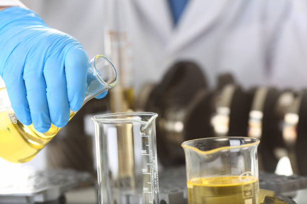 istock Male hands in protective gloves hold test tube 954353800