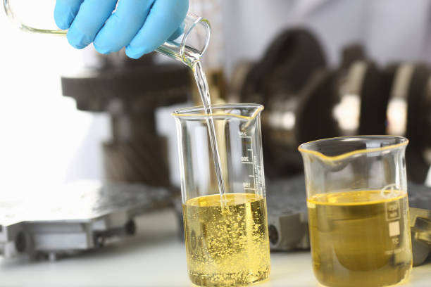 istock Male hands in protective gloves hold test tube 954353804