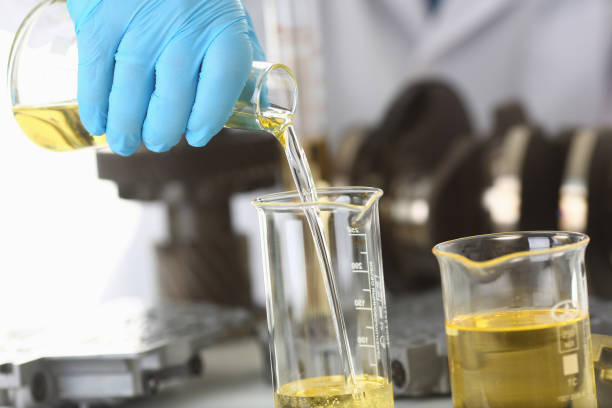 istock Male hands in protective gloves hold test tube 954353806