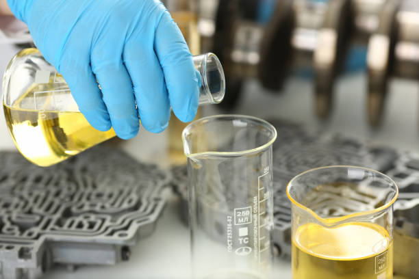 istock Male hands in protective gloves hold test tube 954353816