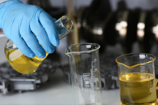 istock Male hands in protective gloves hold test tube 954353820