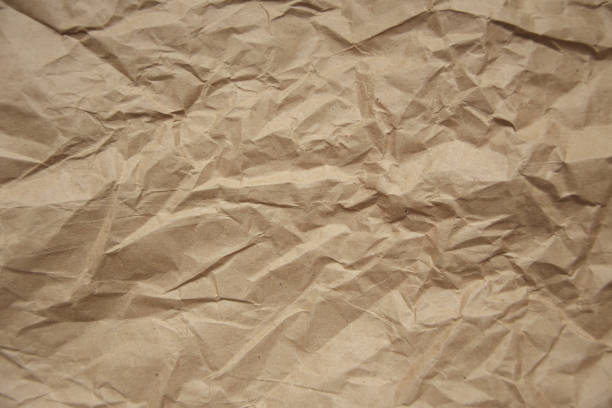 istock Brown rough crumpled recycled paper texture 954354018
