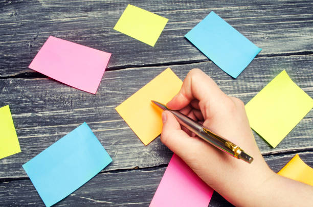 istock sticky stickers for notes on a black wooden background. time management, creative new idea. bad memory. reminder 954356492
