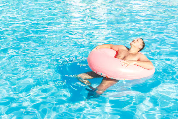 istock man walking in the swimming pool on sunny day ,feeling relax 954361912