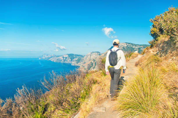 istock man hiking along beautiful coastal trail 954365198