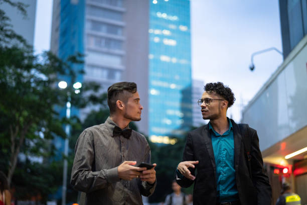 istock Latin Coworkers Walking and Discussing Ideas After Work 954367344
