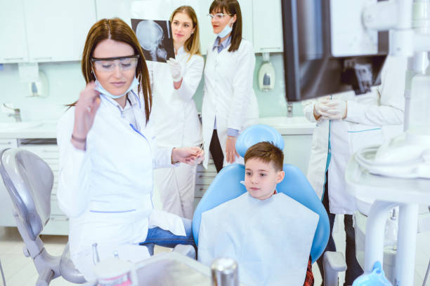 istock Group of Doctors Preparing to Do Young Boy Regular Check up in Clinic 954371256
