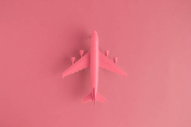 istock High angle view of model commercial plane red color concept. 954371690