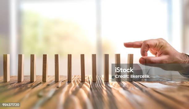 Domino Effect Just Starting Or Triggering Multi Effective Business Process Stock Photo - Download Image Now