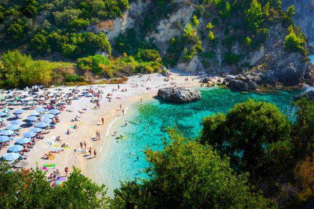 Beach in Parga Beautiful landscape of Parga, panoramic view of the Piso Krioneri beach with turquoise sea and lots of green around, taken from the hill. parga greece stock pictures, royalty-free photos & images