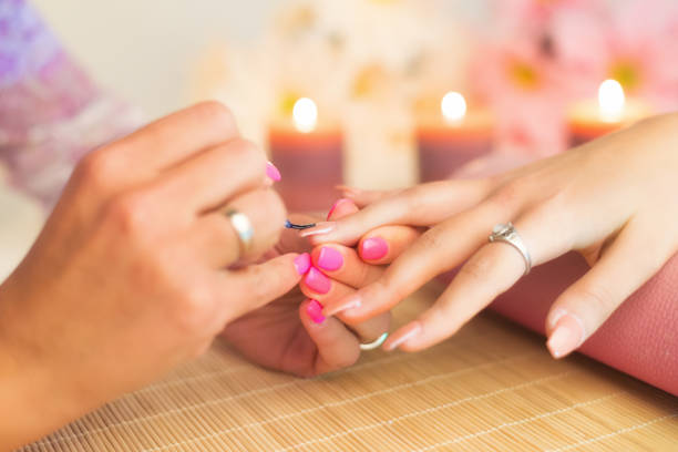 Manicure process in a professional beauty salon, making of artificial nails.