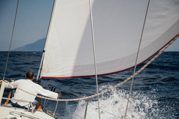 istock Sailboat sailing toward remote island 954386446